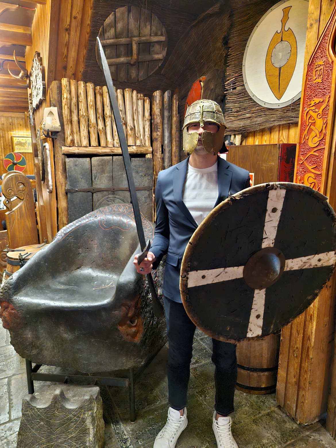 Javier wearing a viking helmet and holding a sword and shield