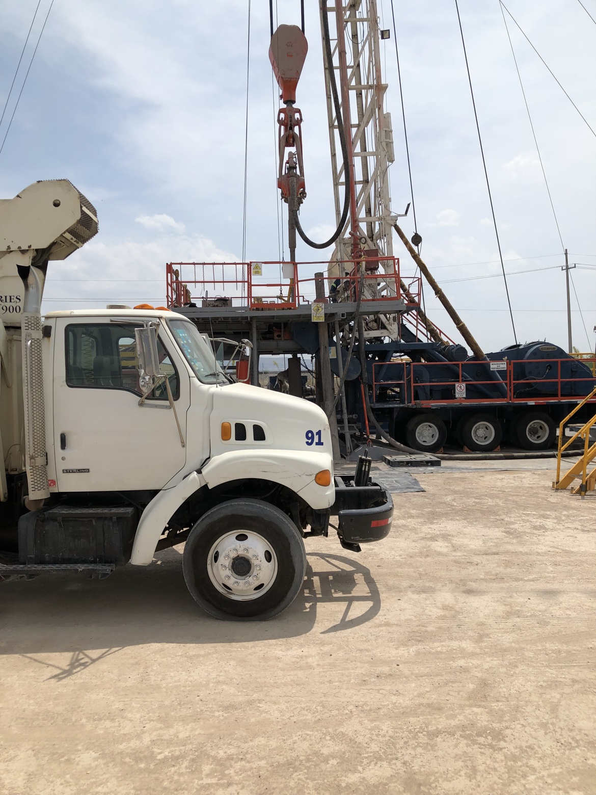 Workover rig with white truck 91
